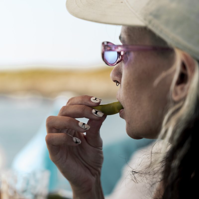 Guest tasting seafood during a private boat tour Mallorca