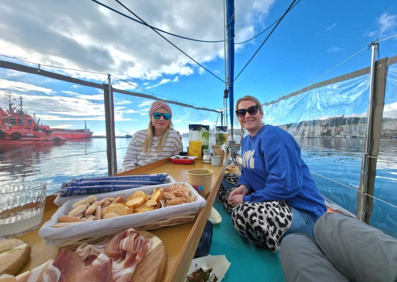 Guests enjoying lunch on deck during a sailing experience in Mallorca