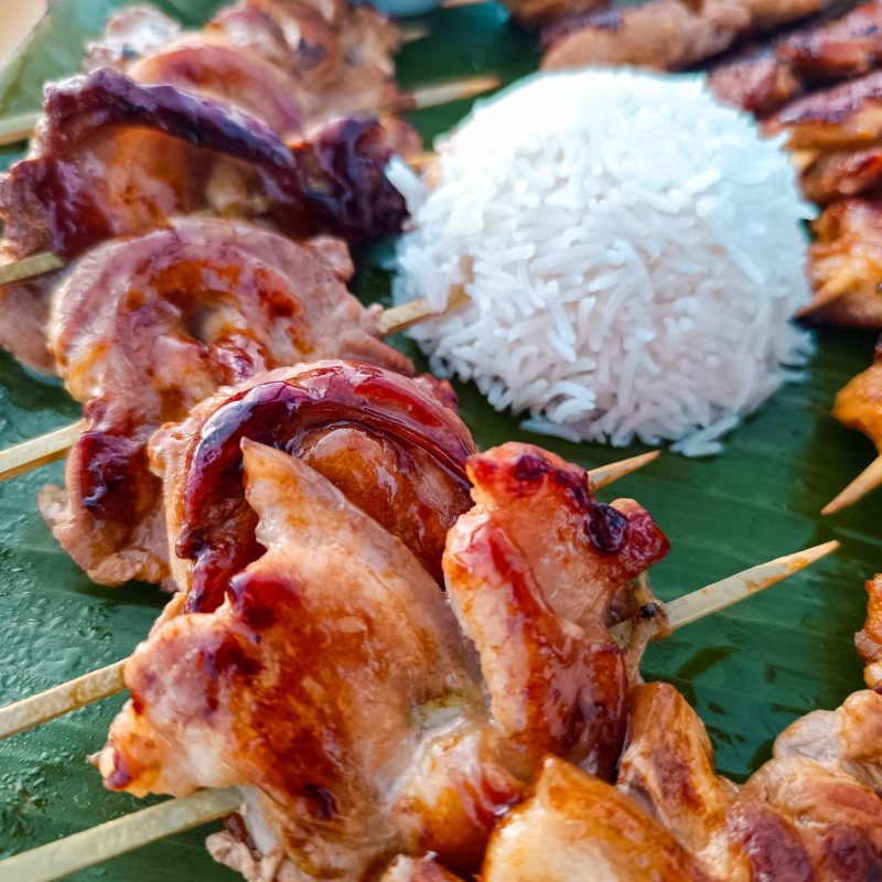 Grilled chicken skewers with rice served during sailing Palma de Mallorca