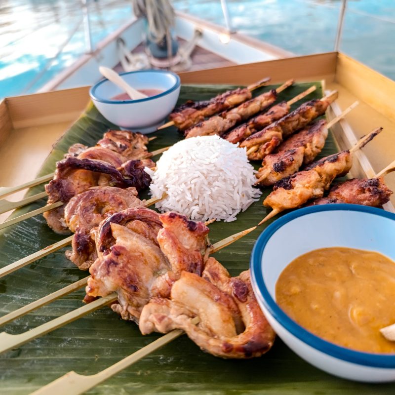 Assorted grilled skewers with sauce during a private sailing experience
