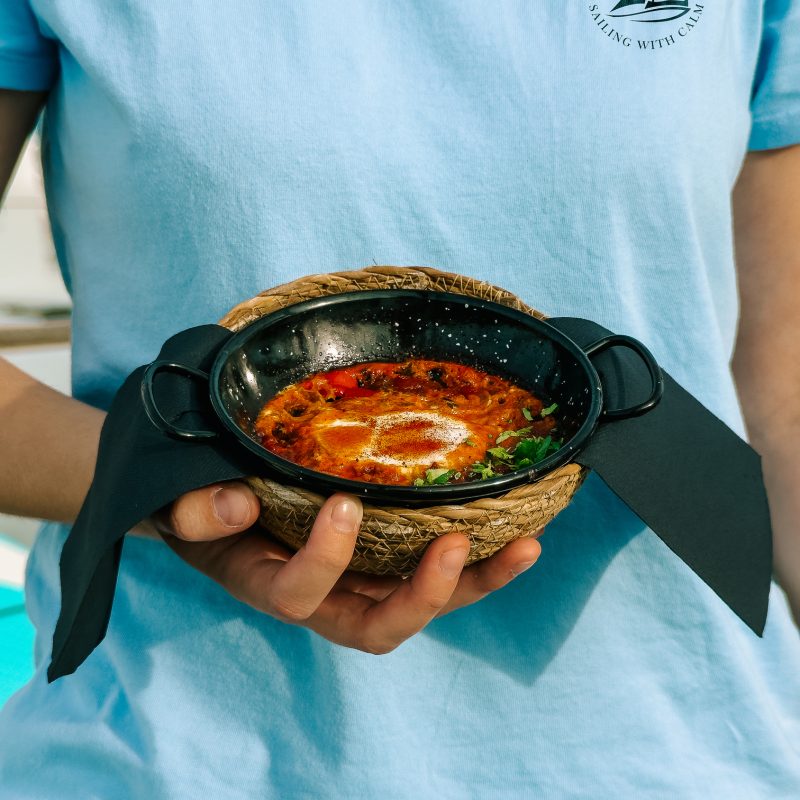 Chef holding a hot dish during a private boat tour Mallorca